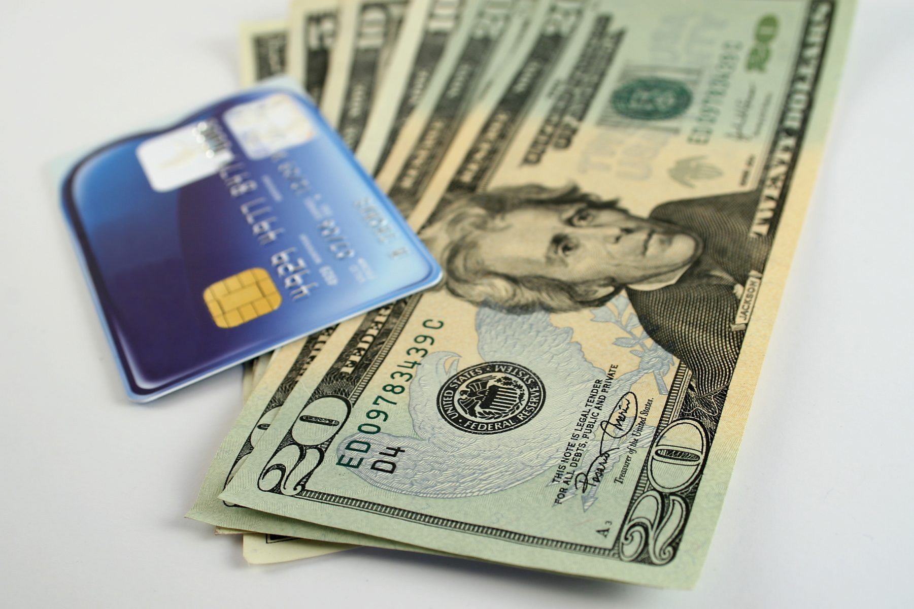 Credit card with stack of 20 bills to represent Cash Advance Services Near Chicago.