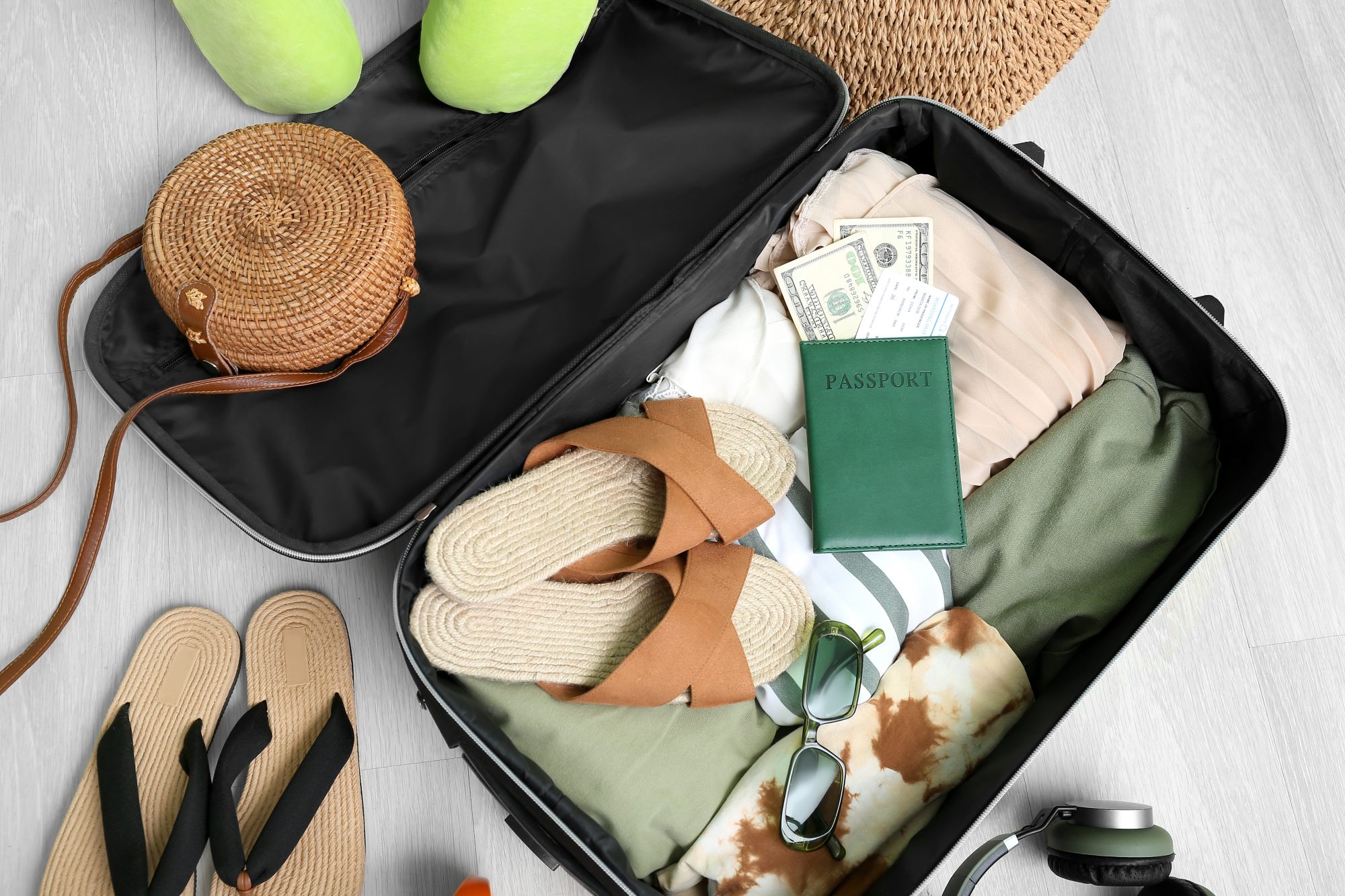 Suitcase packed for trip with passport and money, contact our office for Currency Exchange Service in Chicago.